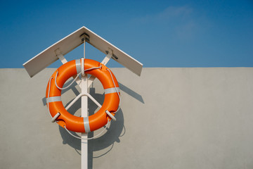 Orange life buoy on the pier