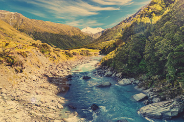 Wild New Zealand river in Mount Aspiring National Park, New Zealand, with vintage filter