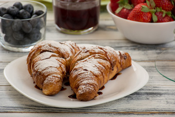 Croissant with chocolate syrup