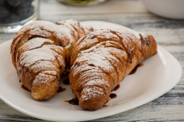 Croissant with chocolate syrup