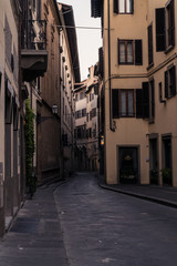 Narrow street and buildings near the River in Florence Italy, at dawn.