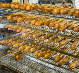 fresh baked baguettes cooling on racks
