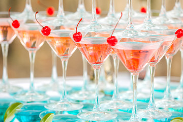 Background of glasses with cocktails and lime