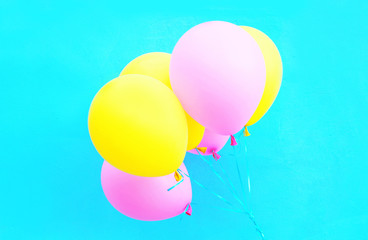 Colorful bundle of air balloons on a blue background
