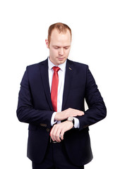 businessman in suit and red tie checking time on his wrist watch. mens hand with a watch, watch on a man's hand, the fees of the groom, wedding preparation, preparation for work, man's style on white