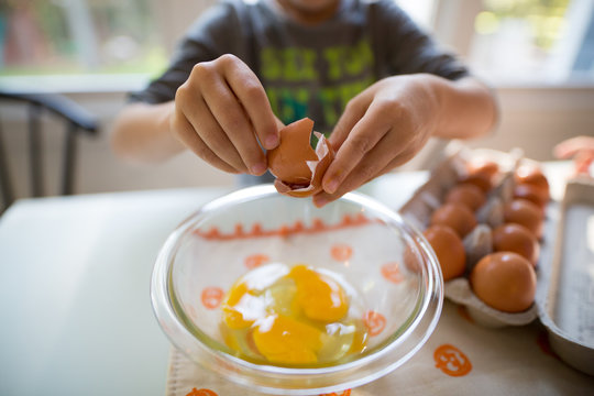 Cracking eggs into a bowl