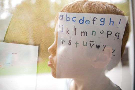 Boy's head double exposure with alphabet 