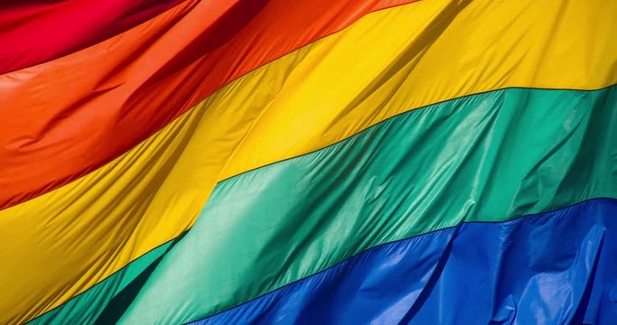 Slow motion gay pride flag blowing in the wind.