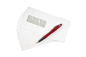 stack of mail envelopes and a pen