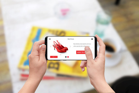 Woman buy online red shoes with smart phone. Responsive store web site with add to cart button.