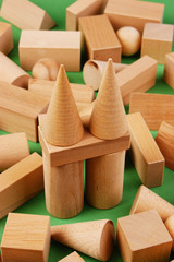 wooden geometric shapes on a green background