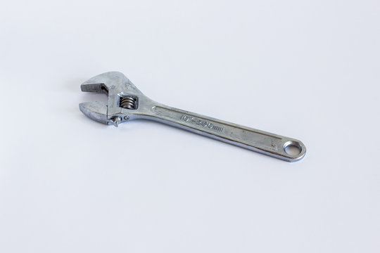 Iron adjustable wrench. Swivel shiny metal key close-up.