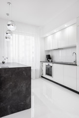 Fototapeta na wymiar White kitchen with dark island