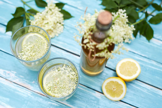 Two glasses of elderflower lemonade and bottle, top view