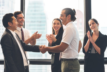 Obraz premium Business People Handshaking after greeting deal with man and women clapping hands background.