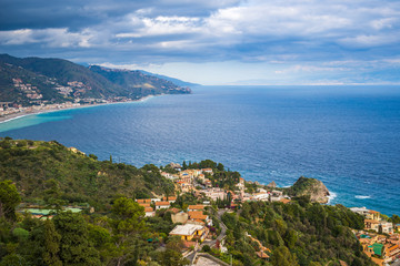Taormina, Italy - Panoramic view of Taormina, Mazzaró with the shores of Italy at the background