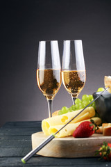 Gourmet Swiss fondue dinner with assorted cheeses on a board and