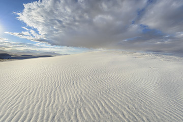 Rippled Pattern in Sand Dunes with Dramatic Clouds