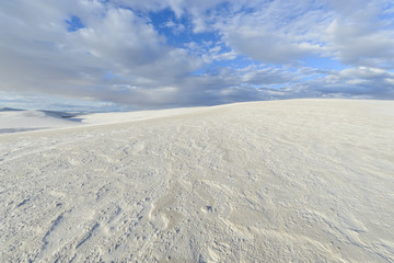 Fototapeta na wymiar Bright White Sand Dunes Shaped by Wind and Rain