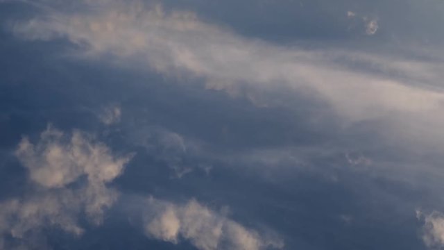 Clouds running across the rapidly darkening sky at sunset. Timelaps, 4K