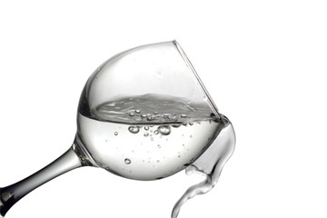 Water pours into a glass on a white background, monochrome image
