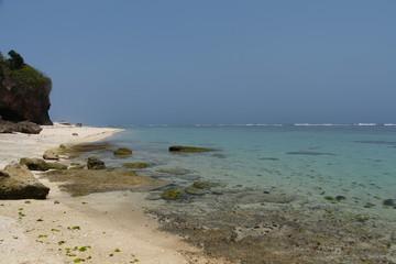 Deserted  white sand beach with rocks