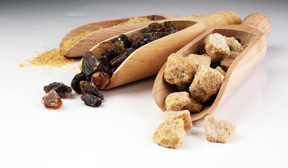 Composition with brown sugar on white background