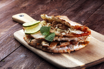 Delicious kebab sandwiches on wooden table
