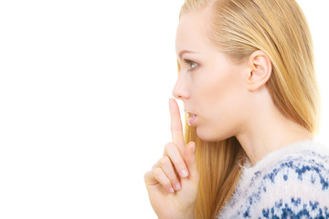 Young blonde woman making silence gesture