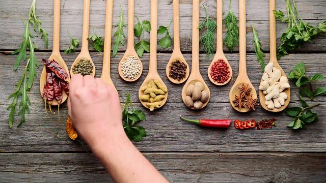 Different spices and fresh herbs on a wooden table