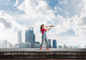 Concept of careless happy childhood with girl exploring this world