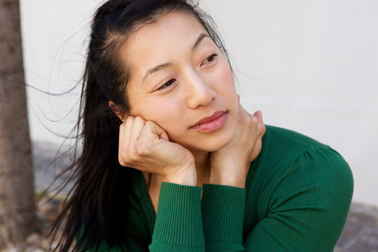 Close Up Asian Woman Sitting Outside And Thinking