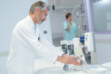 Doctor sanitising hands