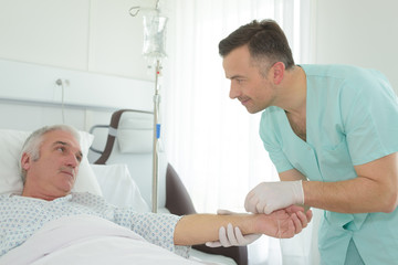 Nurse holding patient's arm