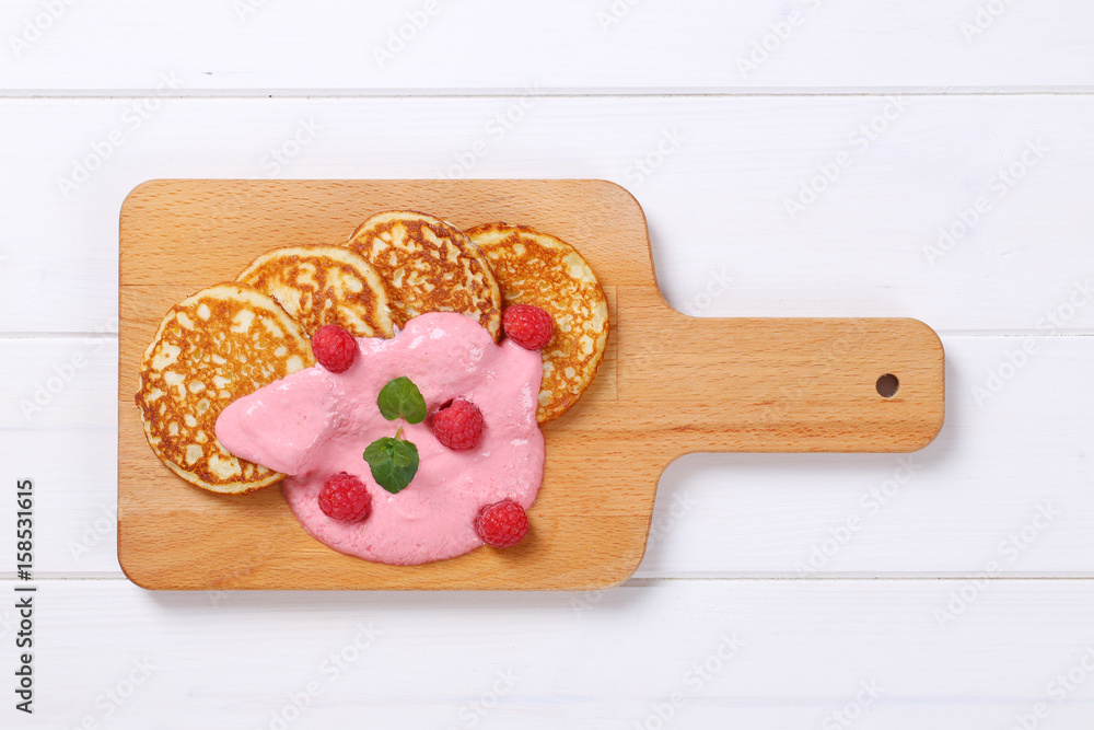 Poster american pancakes with yogurt and raspberries