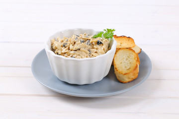 grated cheese and olive spread with crostini