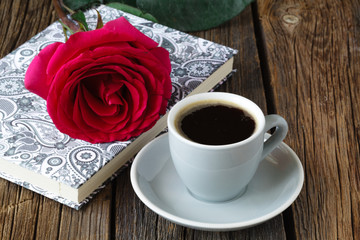 One red roses on the notebook.