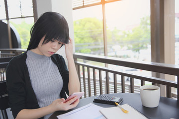  Asian woman with smart phone with business