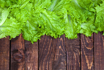 Fototapeta premium Lettuce on wooden table. Top view, copy space
