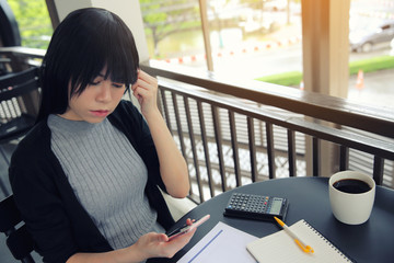  Asian woman with smart phone with business