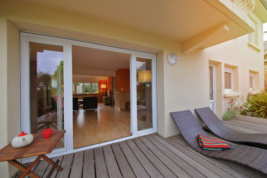 int&eacute;rieur salon maison rez-de-chauss&eacute;e donnant sur terrasse en bois 