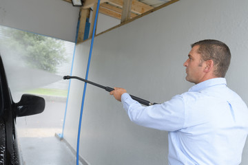 Man power washing vehicle