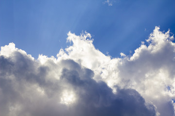 The sun hid behind the clouds on a sunny day