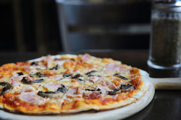 pizza ham and mushroom on wood
