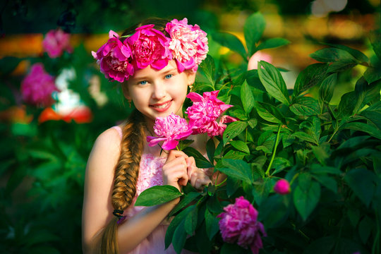 portrait of little girl outdoors with peony