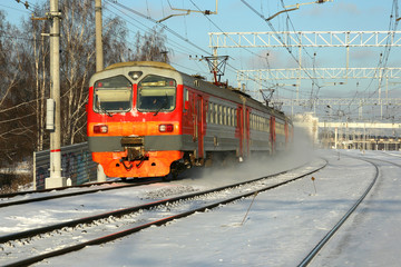 A passenger train goes by rail in winter