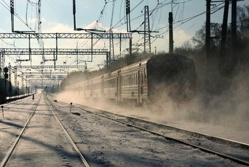 A passenger train goes by rail in winter