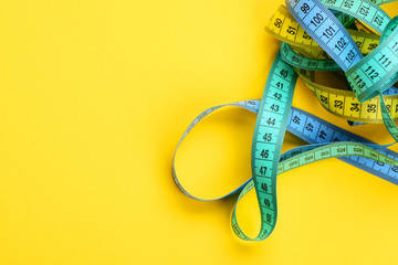 Tapes for measuring in yellow, blue and cyan colours
