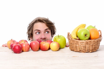 Fototapeta na wymiar Caucasian man with cunning look near red or green apples