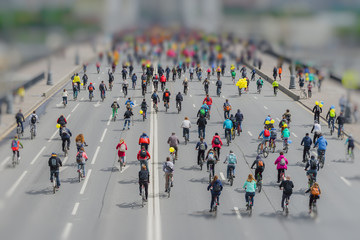 Parade of bicyclists in city center. Mass urban cycling marathon. Youth, families with children...